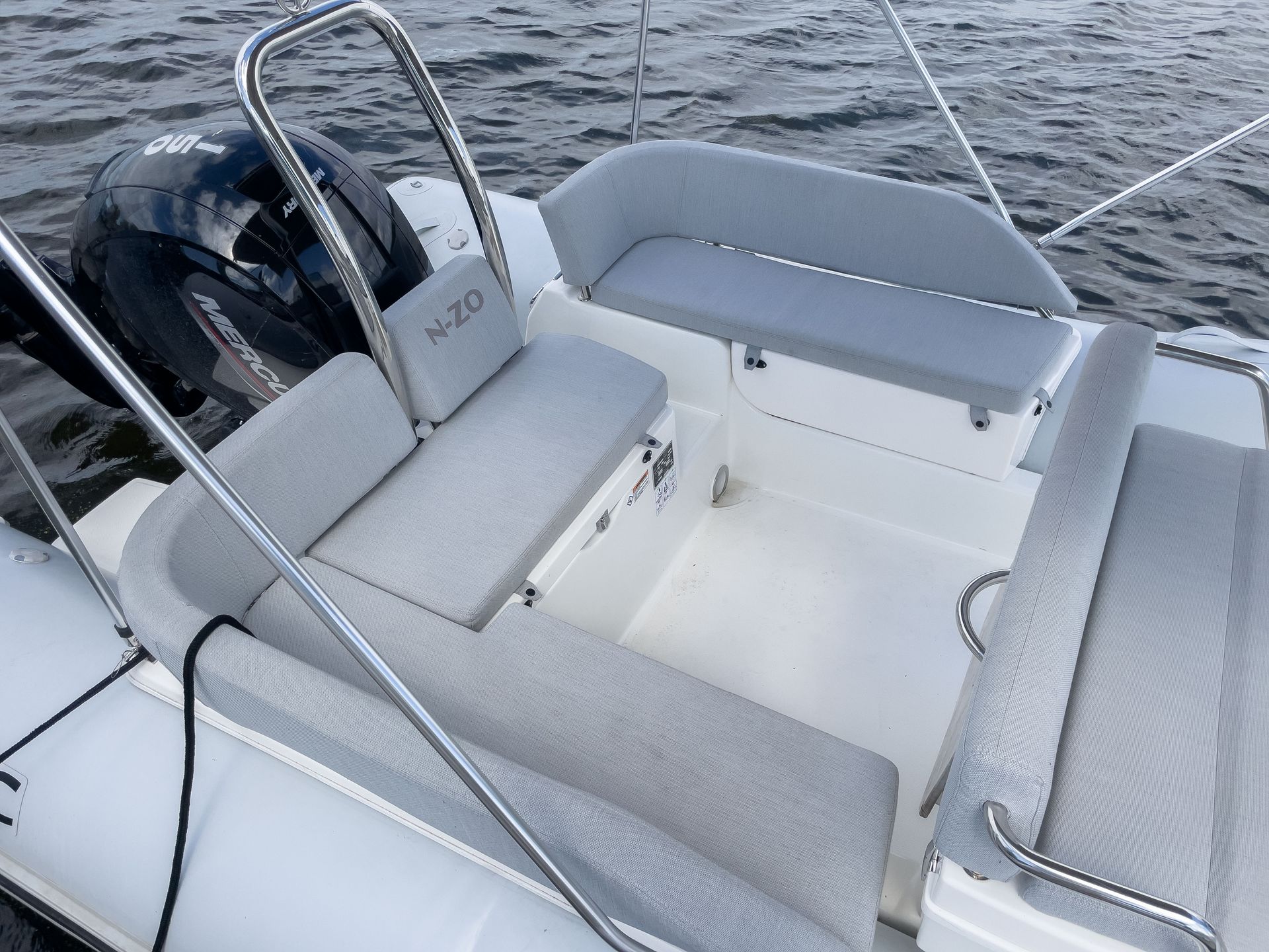 A boat with a seat and a steering wheel in the water
