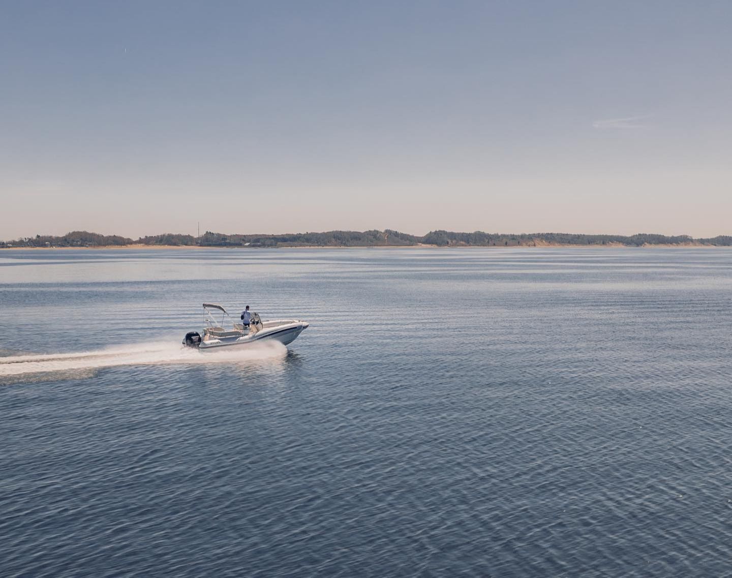A boat is floating on top of a large body of water.