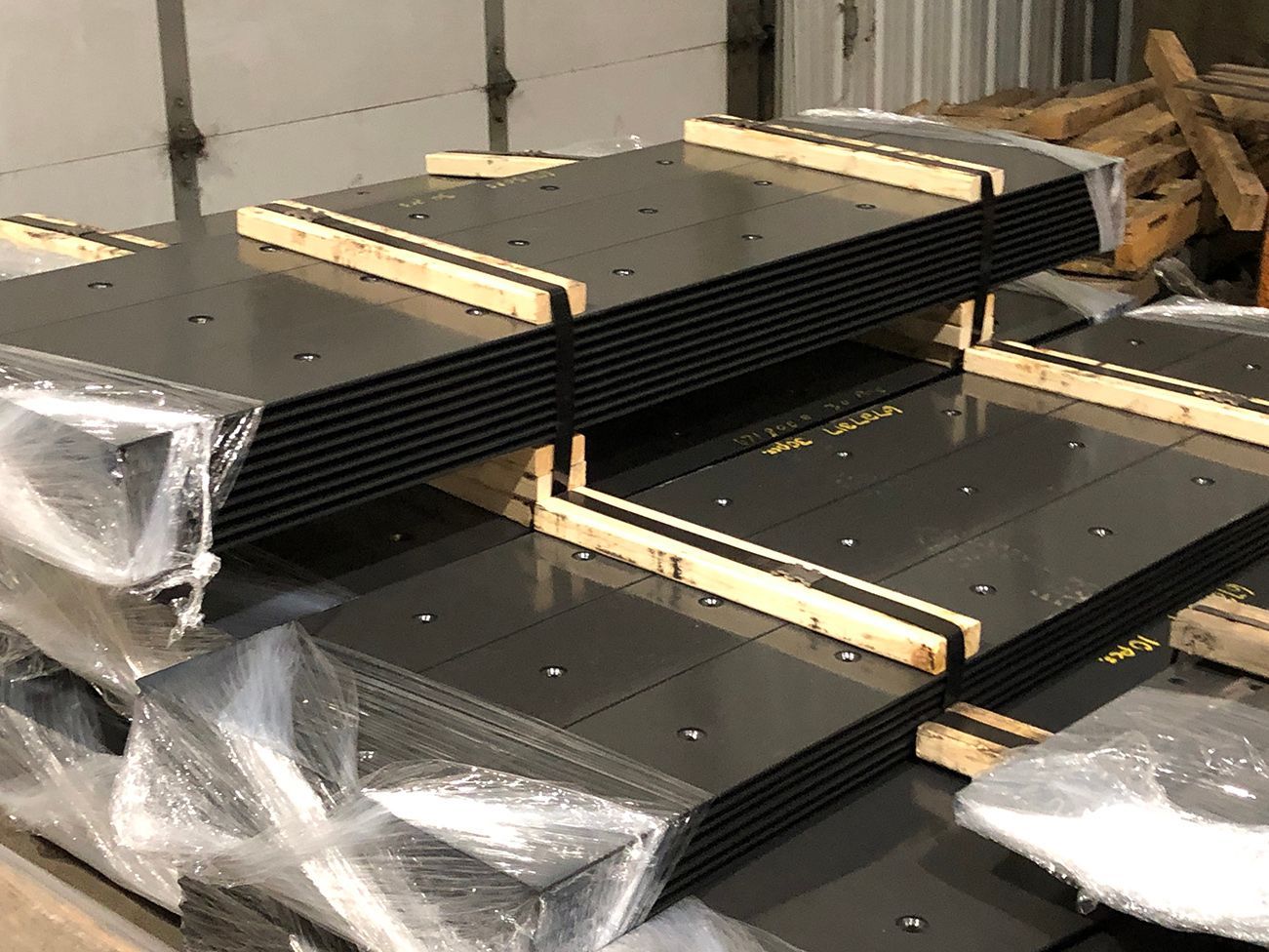 Powder-painted grader cutting edge blades.