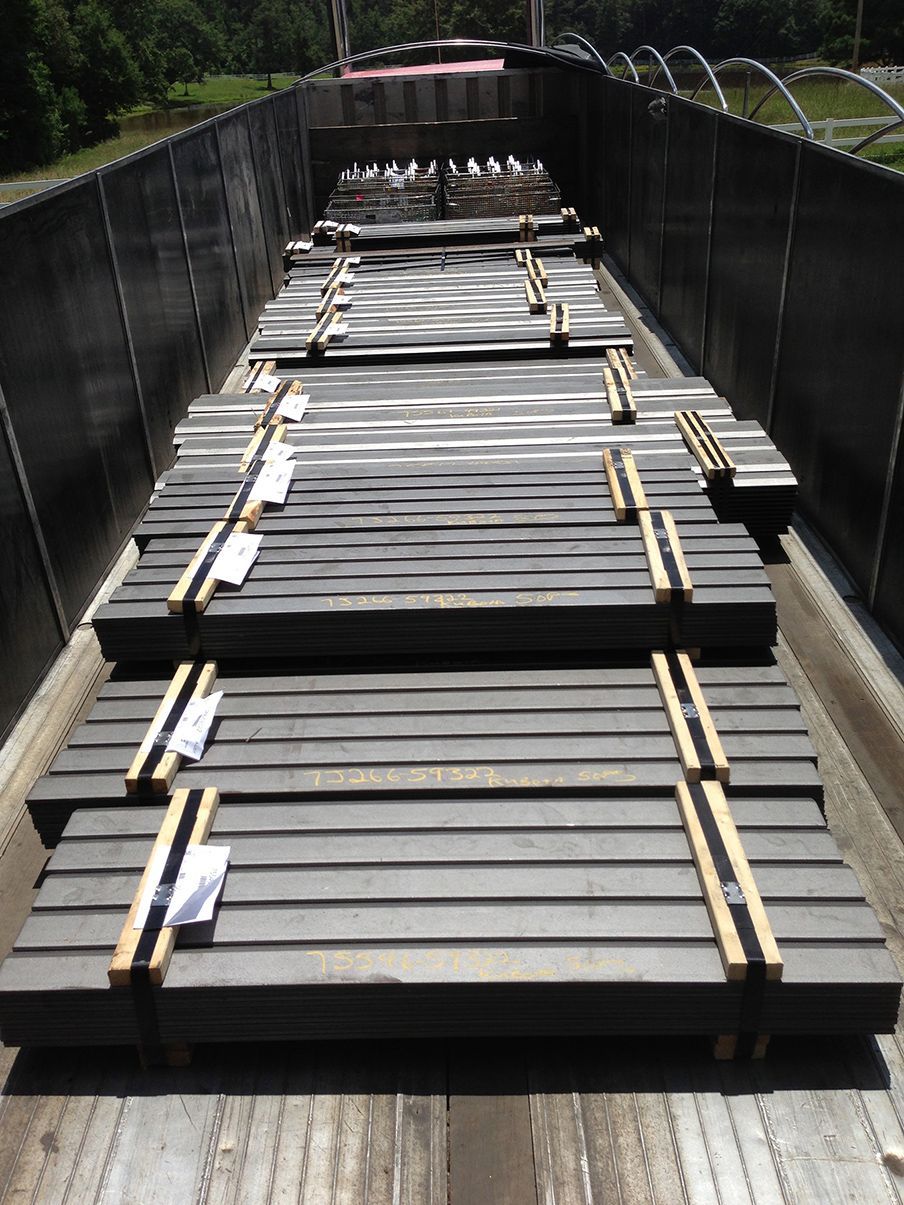 A train car filled with a lot of metal pieces.