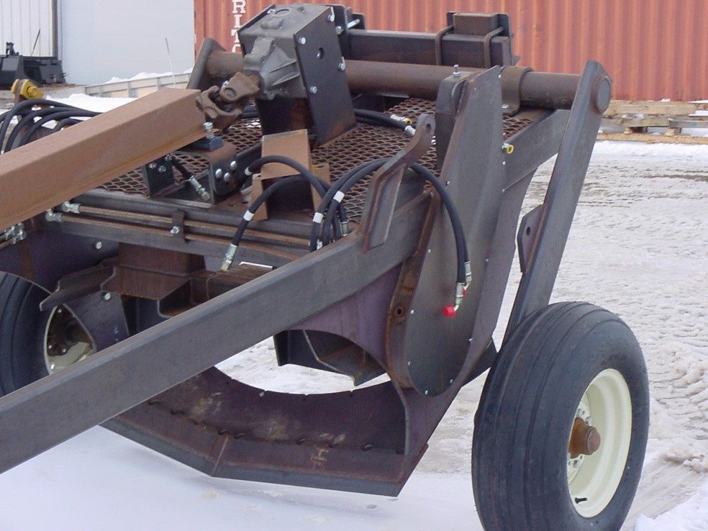 A tractor with a hose attached to it is parked in the snow