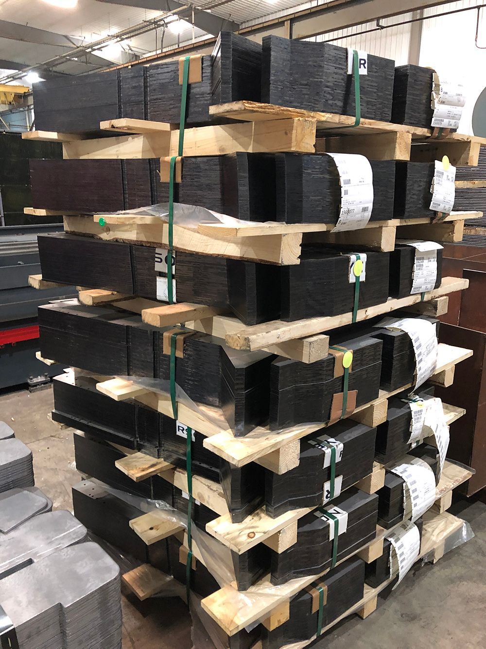 A warehouse filled with lots of wooden pallets stacked on top of each other.