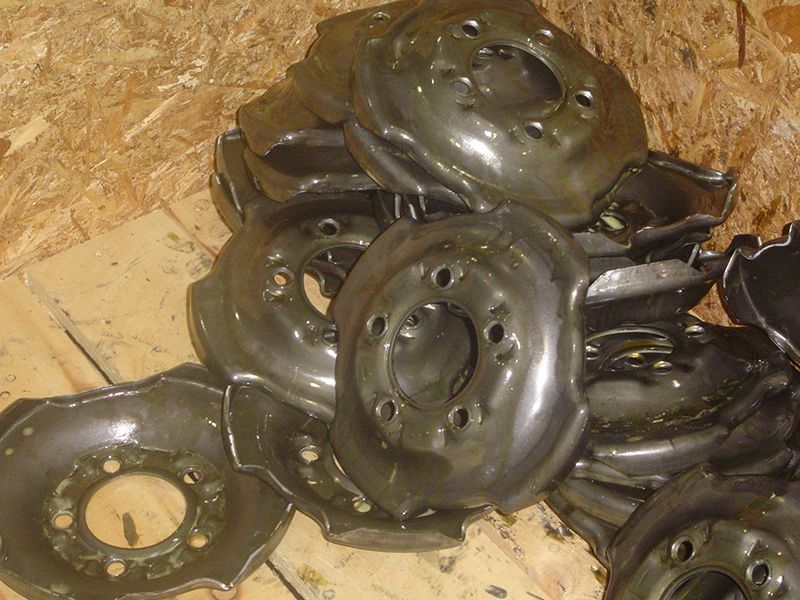 A pile of metal discs with holes in them