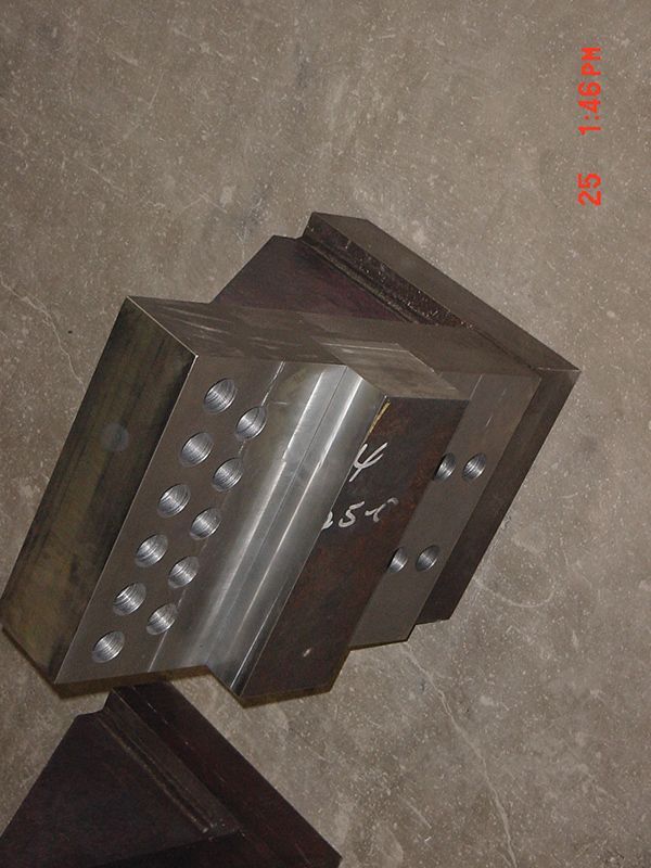 A piece of metal with holes in it is sitting on a table.