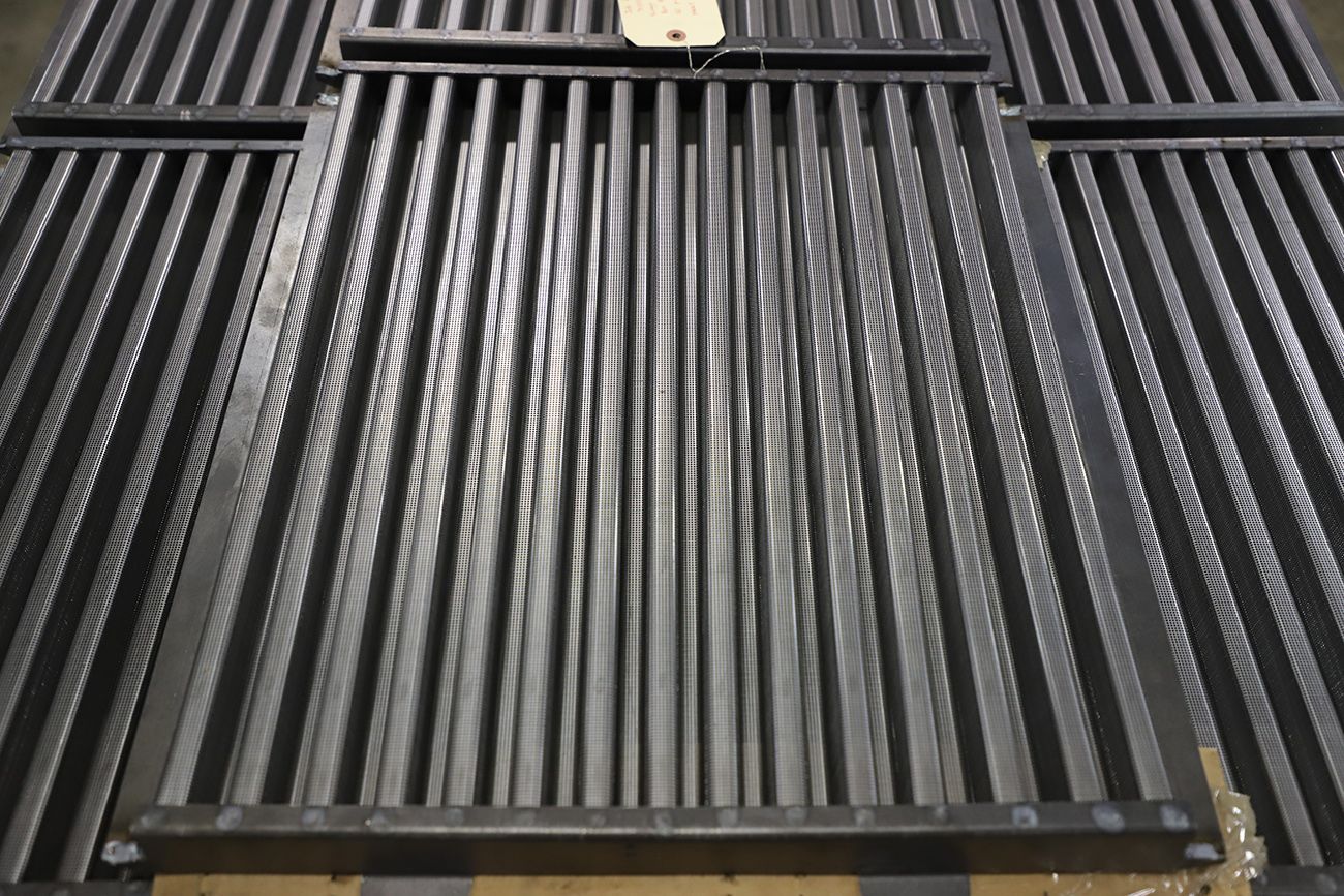 A close up of a metal grate with a tag on it