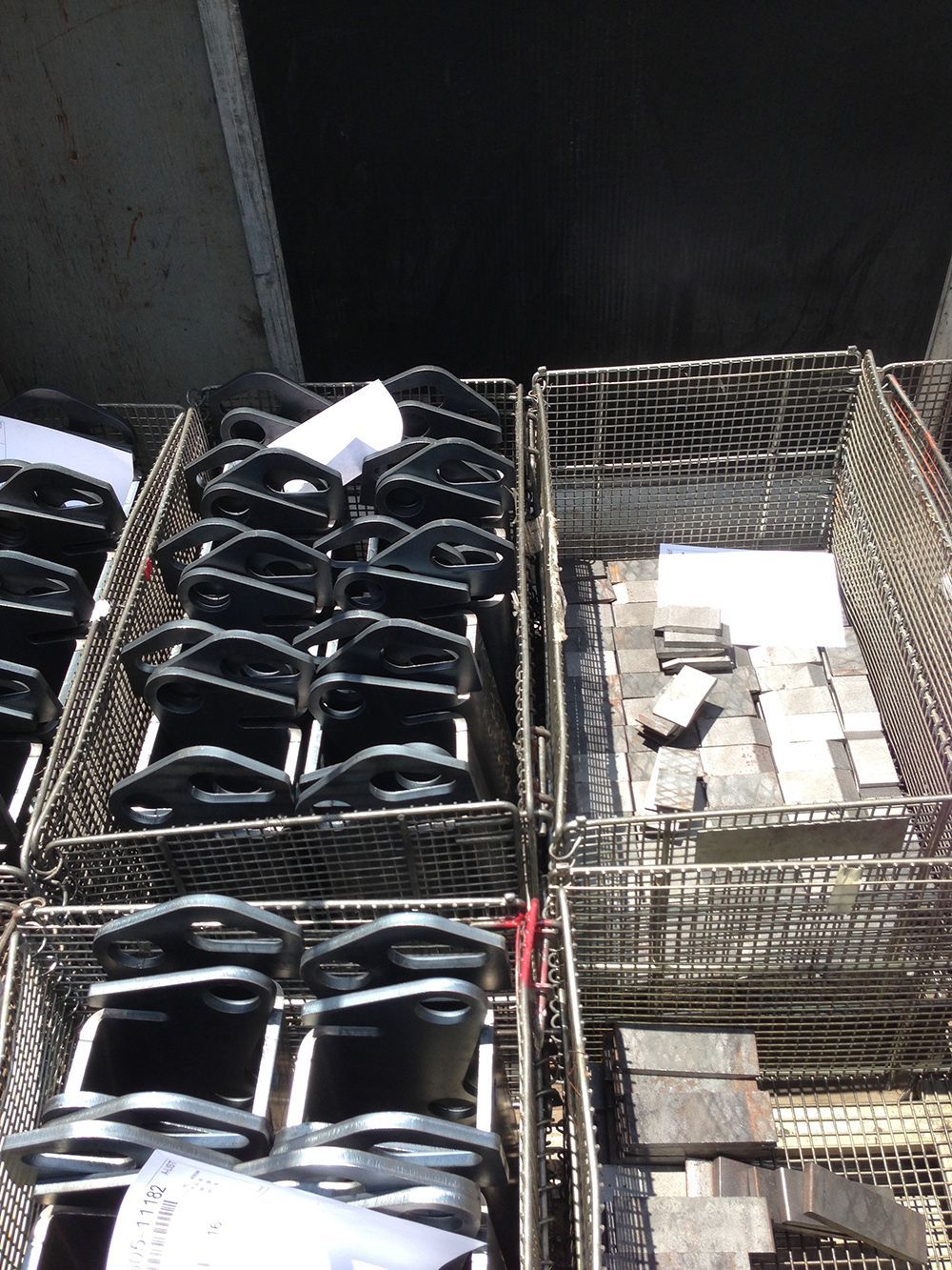 A bunch of wire baskets filled with metal objects.