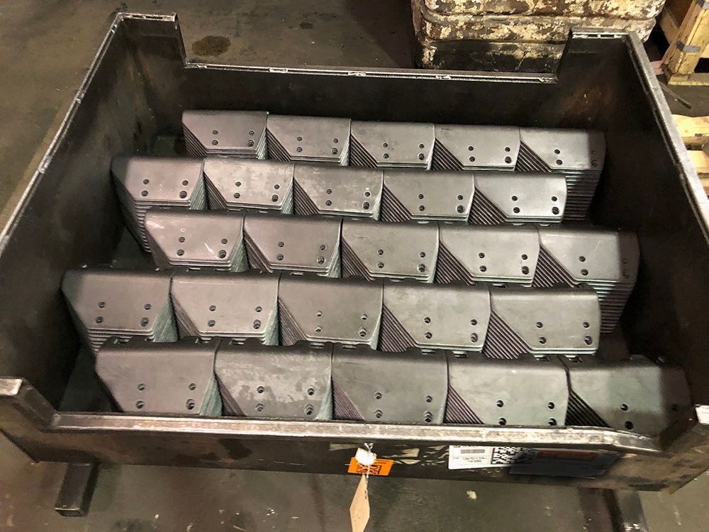 A metal box filled with a bunch of pieces of metal