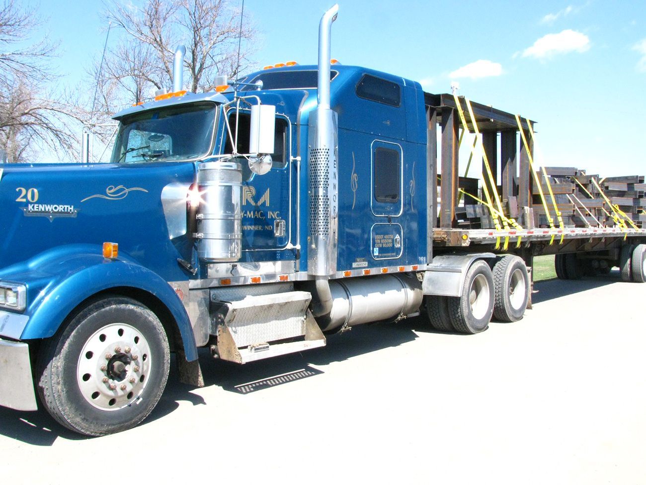 A blue semi truck with the number 20 on it