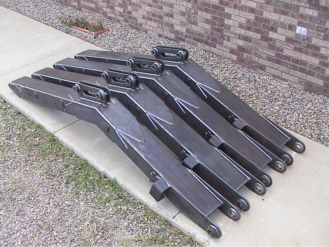 A bunch of pieces of metal are stacked on top of each other on a sidewalk