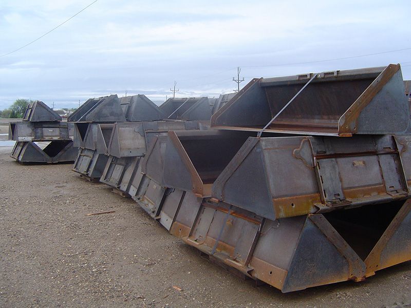 A bunch of metal buckets are stacked on top of each other