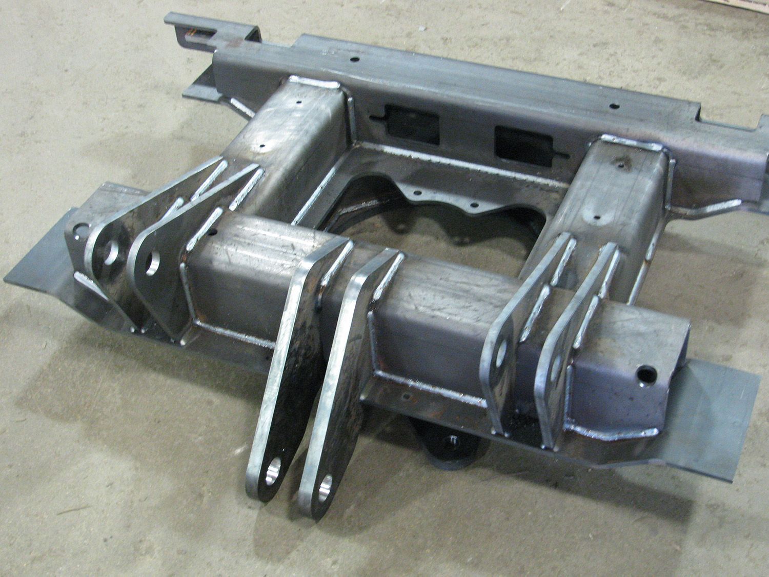 A piece of metal is sitting on a concrete surface