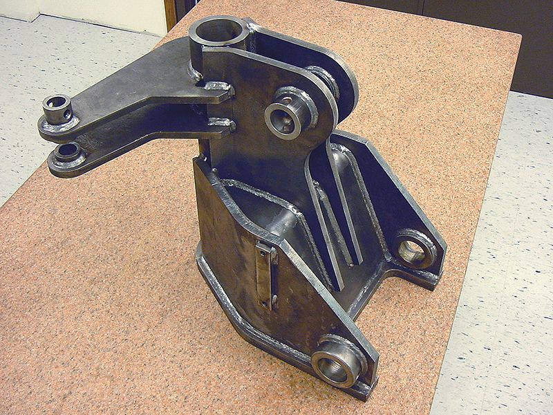 A piece of metal is sitting on a wooden table