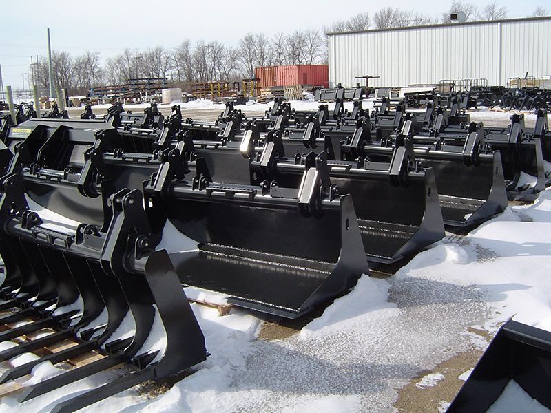 A bunch of black buckets are lined up in the snow