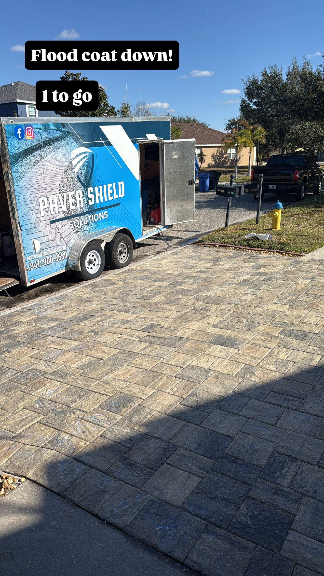 Blue “Freshwater” trailer on a driveway with text overlay, in a sunny outdoor yard.