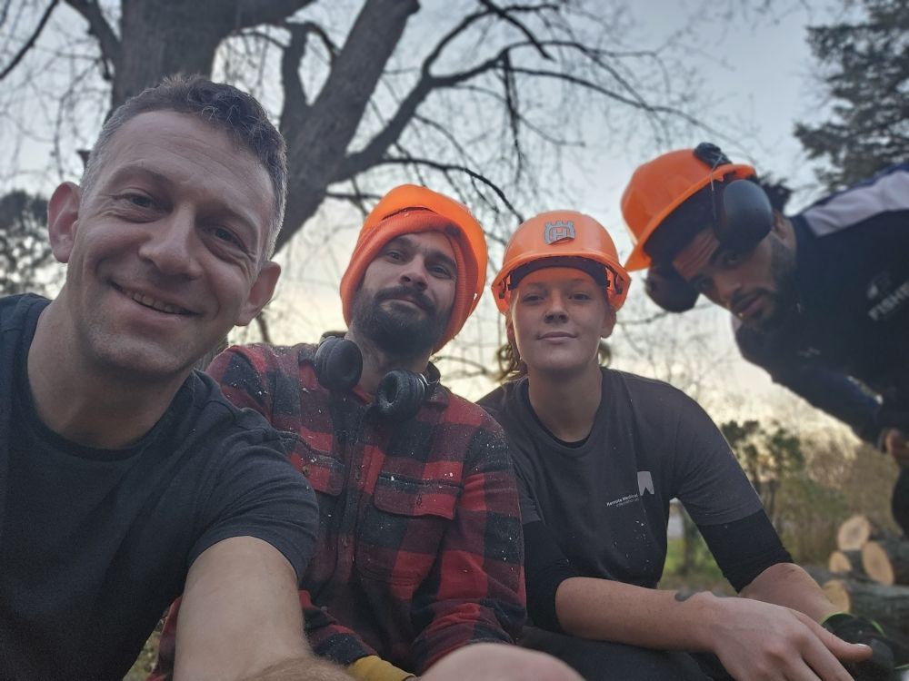 A group of people wearing hard hats are posing for a picture.
