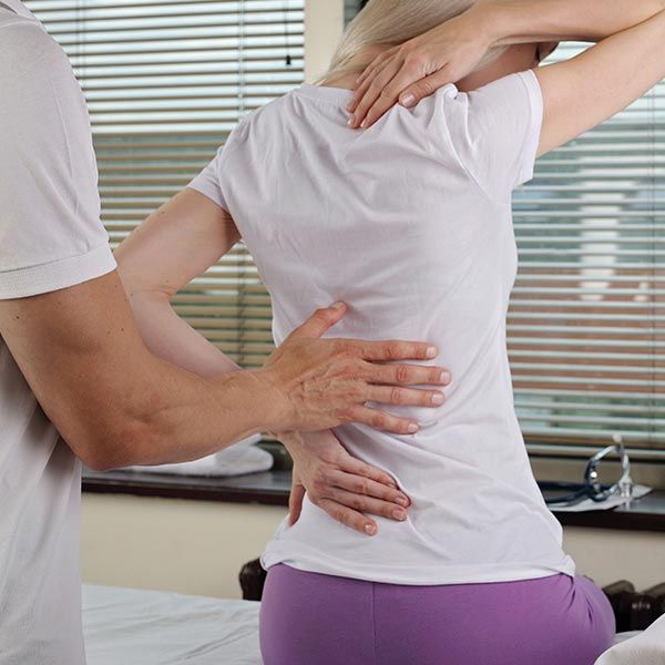 Chiropractor adjusting back spinal