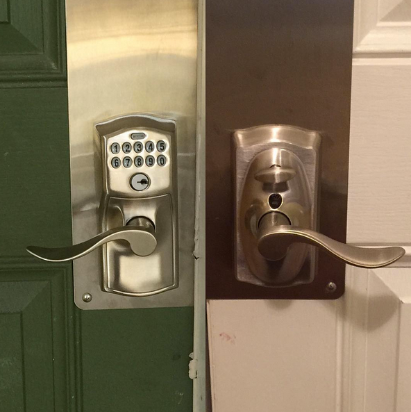 Two adjacent silver door locks with curved handles on green and white doors