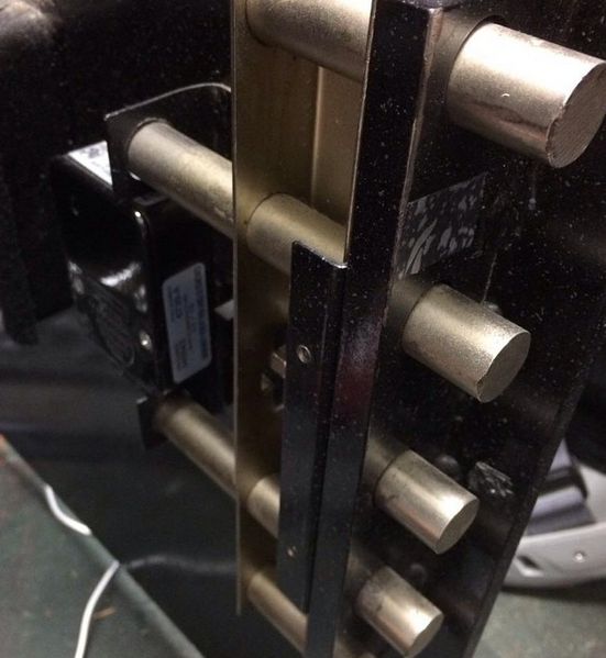 Close-up of a modern metal door handle set on a dark glass door