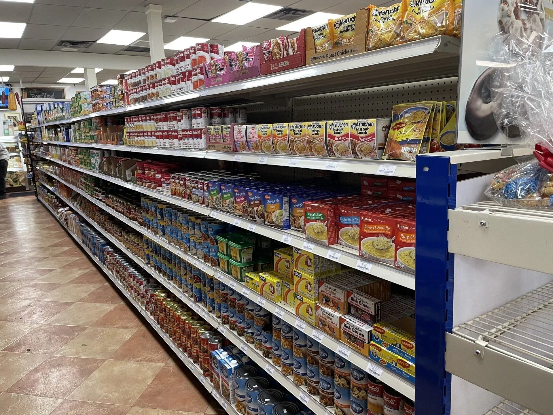 Grocery store aisle with shelves filled with packaged food products.