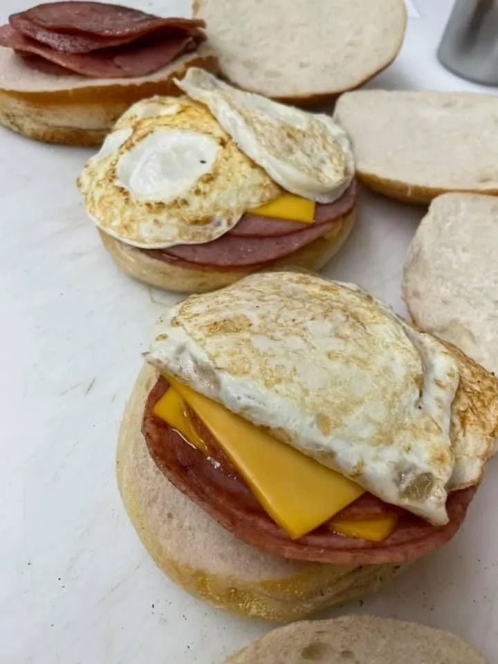 English muffins with fried egg, cheese, and ham.
