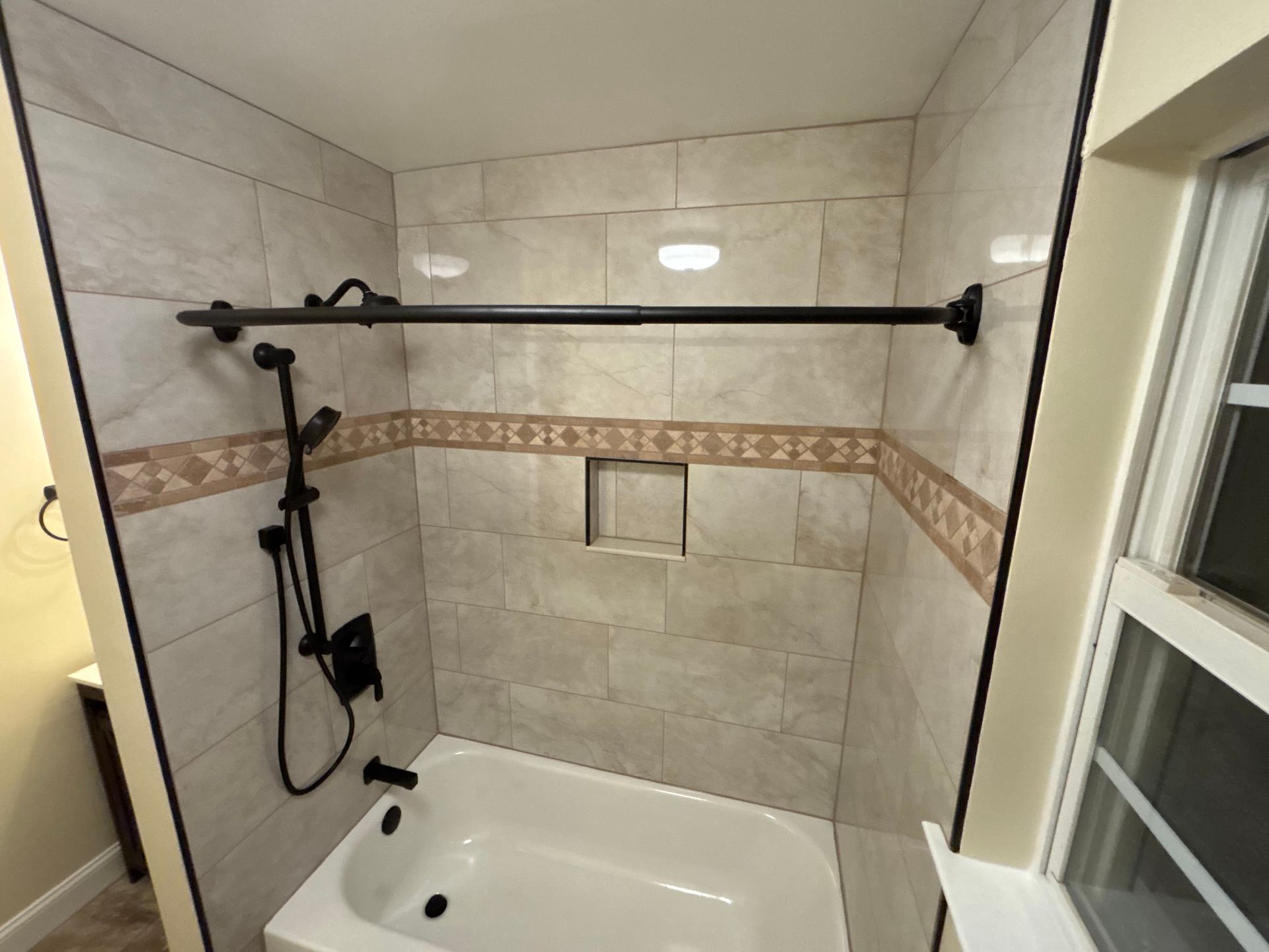 A bathroom with a bathtub and a shower.