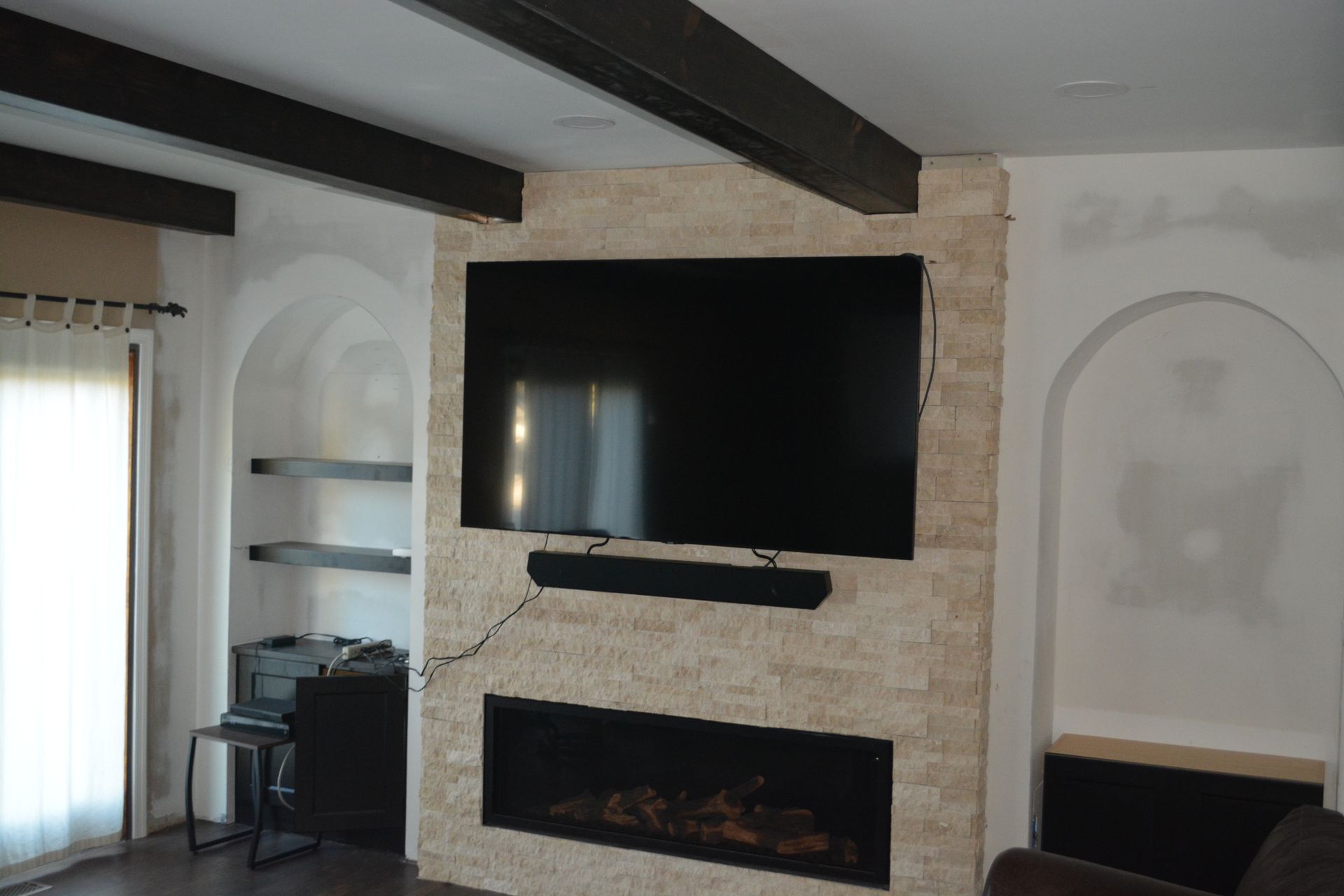 A living room with a fireplace and a flat screen tv