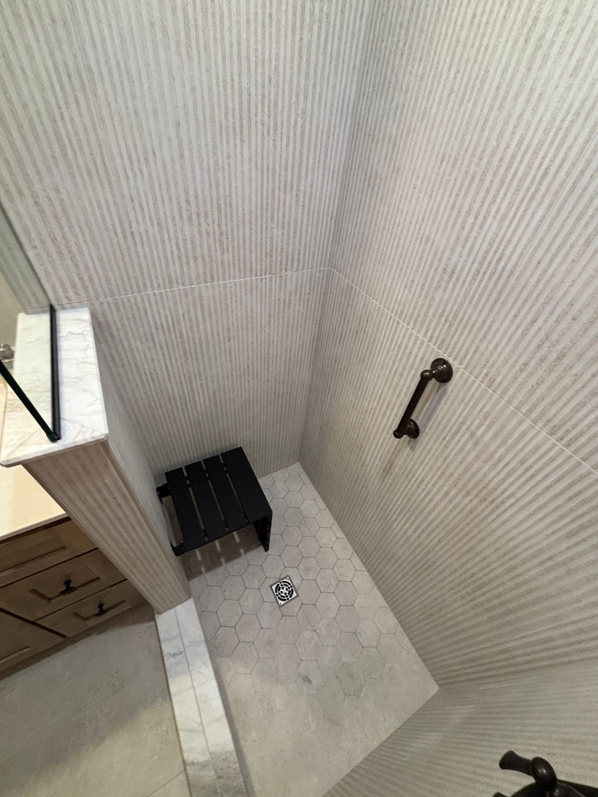 An aerial view of a bathroom with a walk in shower.