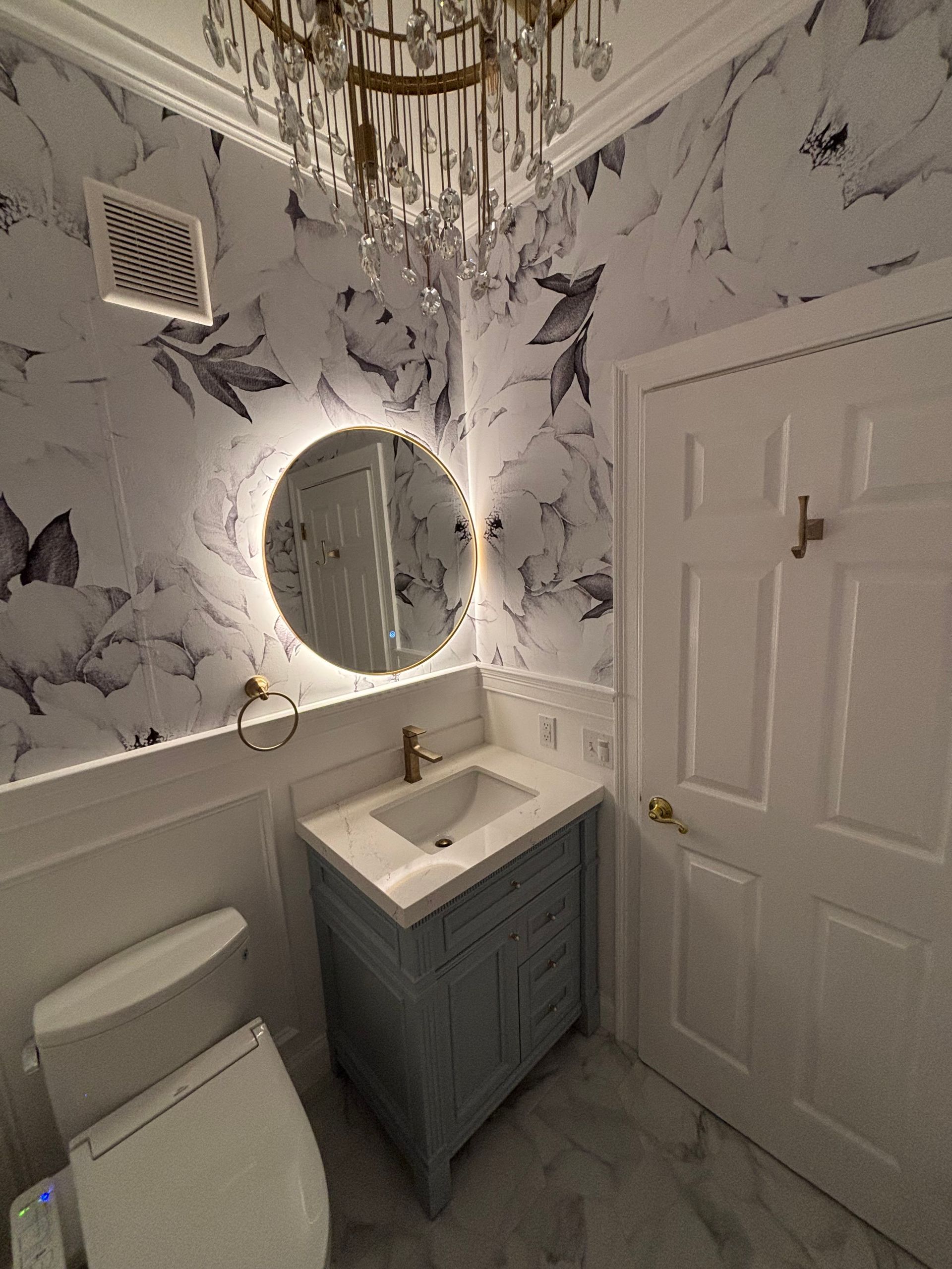 A bathroom with a sink , toilet , and mirror.