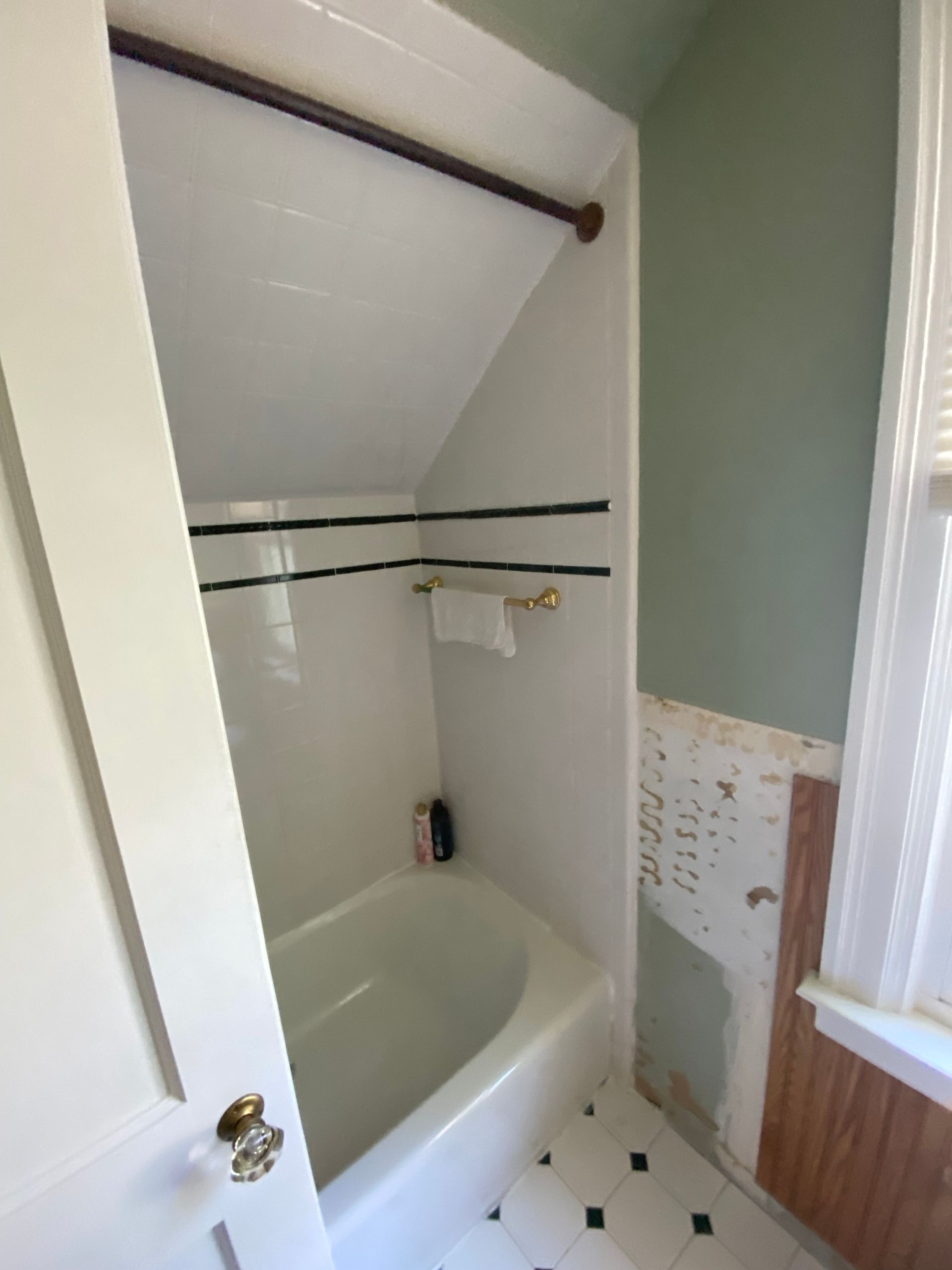 A bathroom with a bathtub and a window