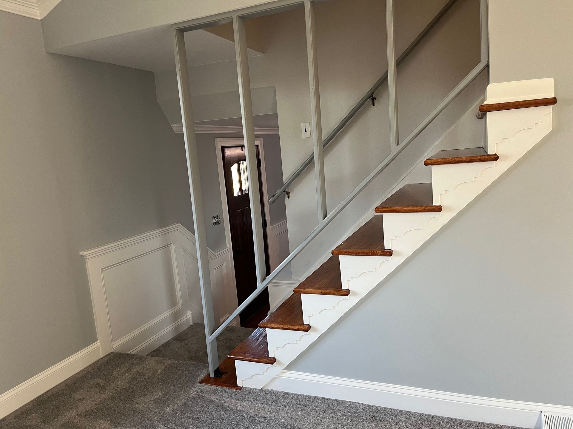 A staircase with wooden steps and a metal railing