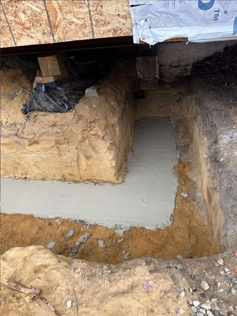 A hole in the ground with a concrete slab in it.