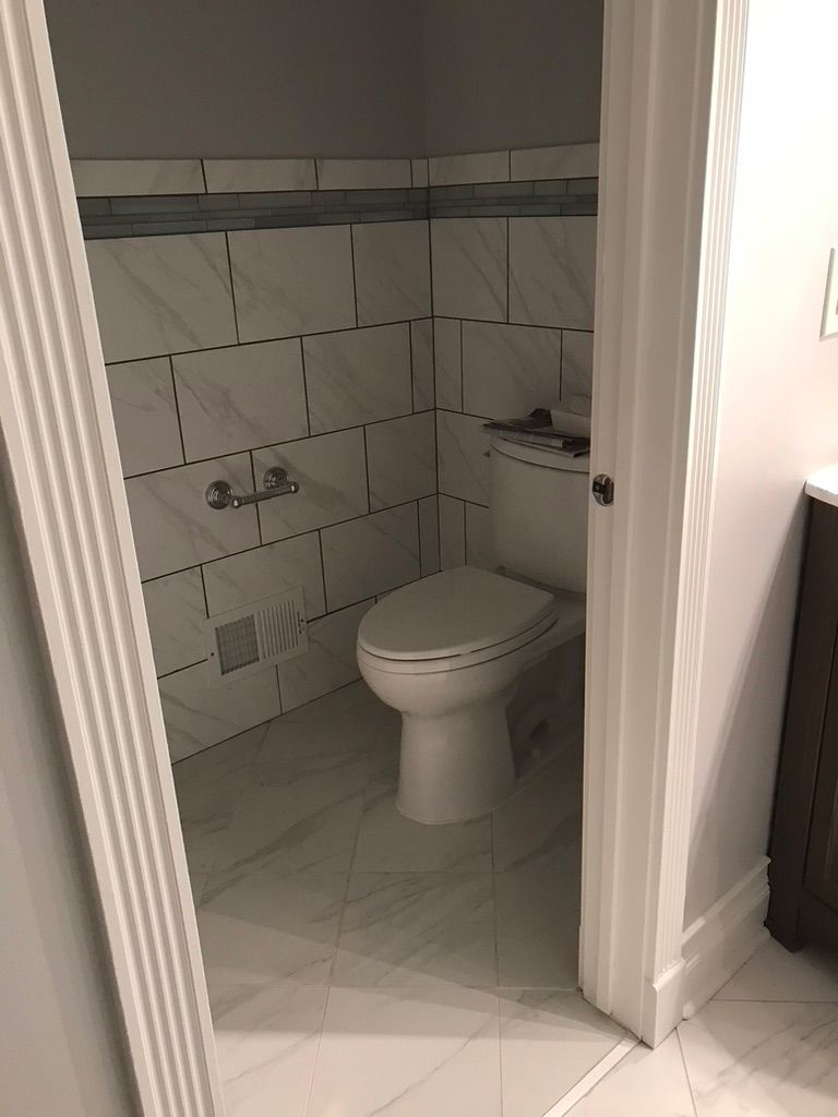 A bathroom with a toilet and a sink in it.