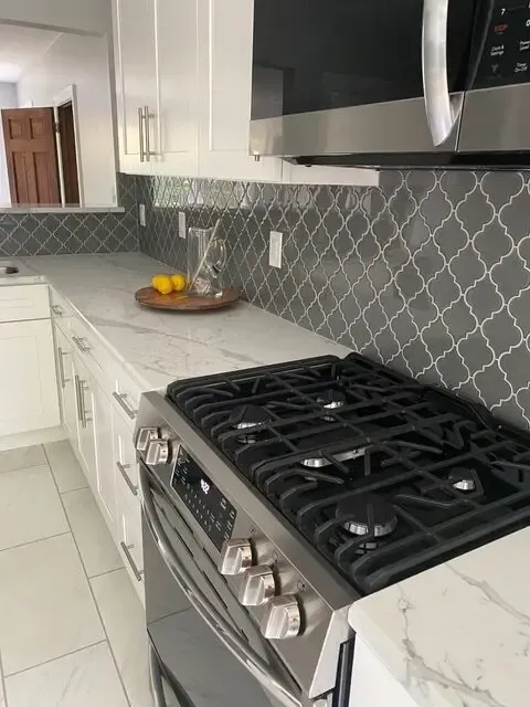A kitchen with a stove top oven and a microwave.