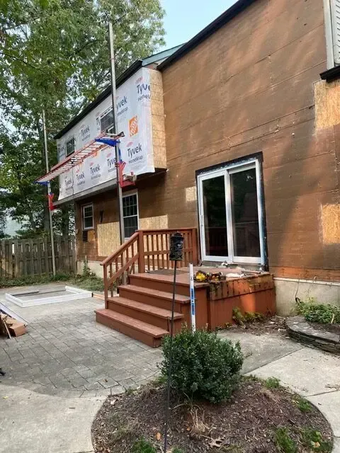 A house with a deck and stairs is being remodeled.