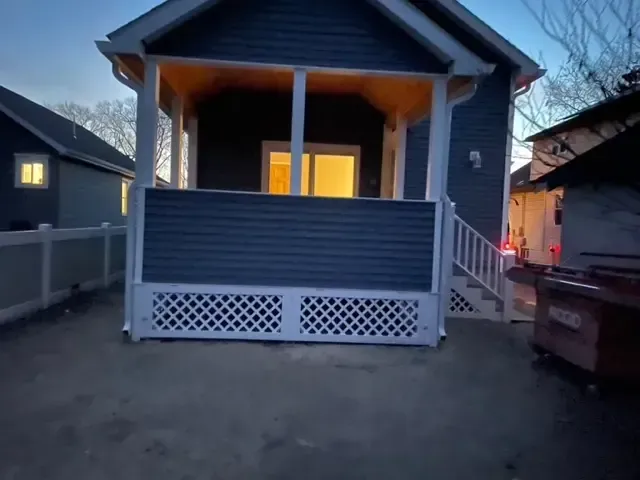 A small house with a porch and stairs
