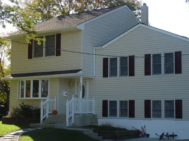 A white house with black shutters on the windows