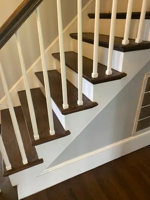 A staircase with white railings and wooden steps