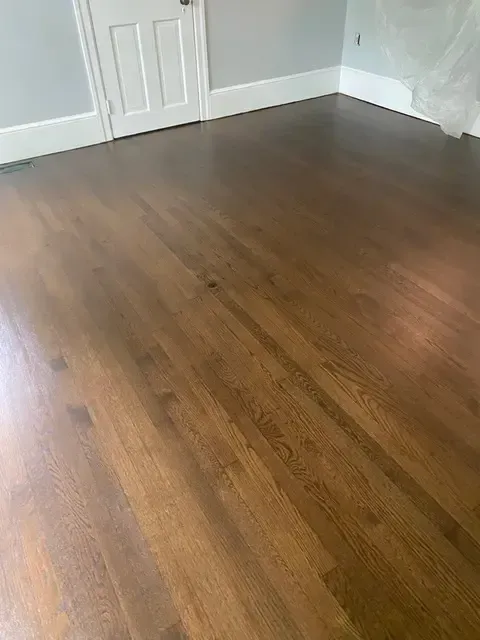 A room with a wooden floor and a door.