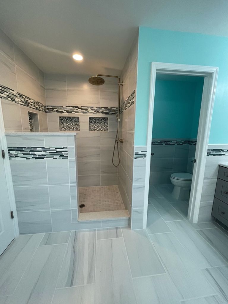 A bathroom with a walk in shower and a toilet.