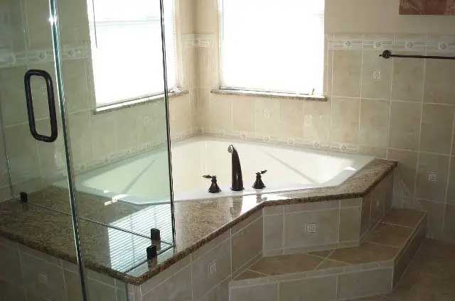 A bathroom with a jacuzzi tub and a shower