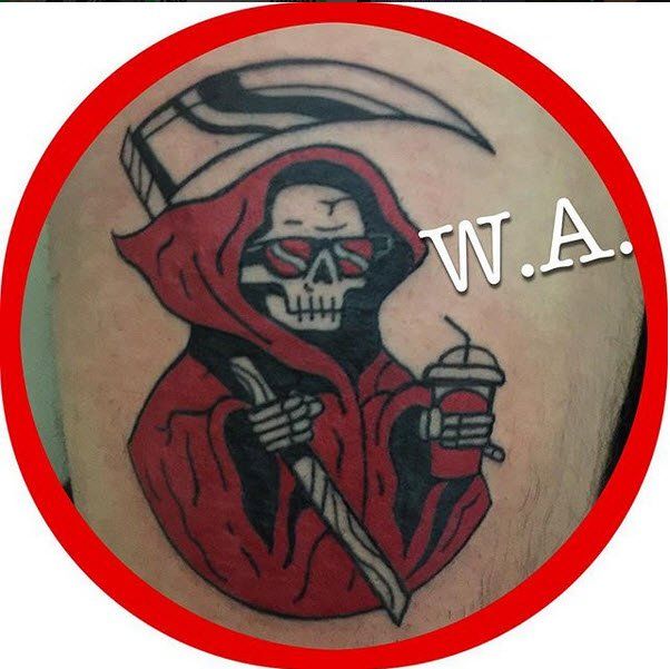 Grim Reaper tattoo in red hood, holding scythe and drink, wearing sunglasses, inside red circle.