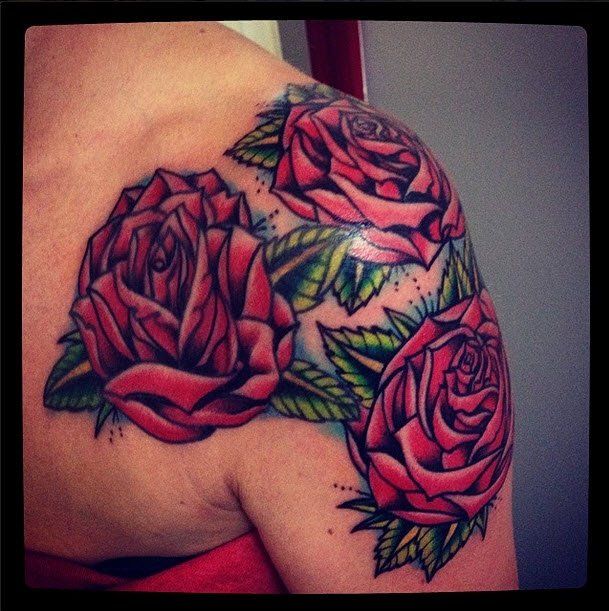Three red rose tattoo on a shoulder. Green leaves, black outlines.