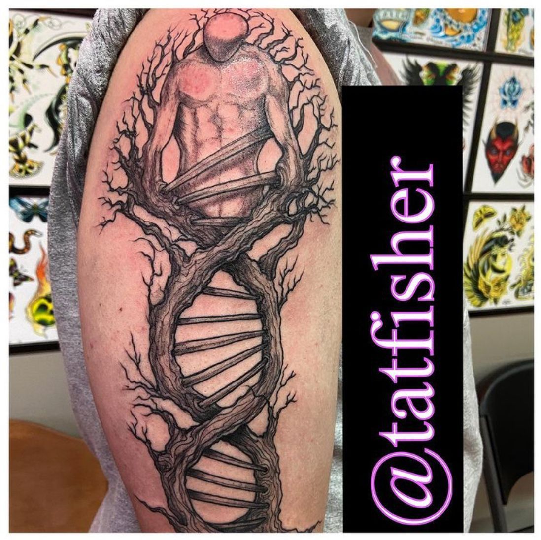 Tattoo of a human figure within a DNA helix-shaped tree on an arm, with tattoo designs in the background.