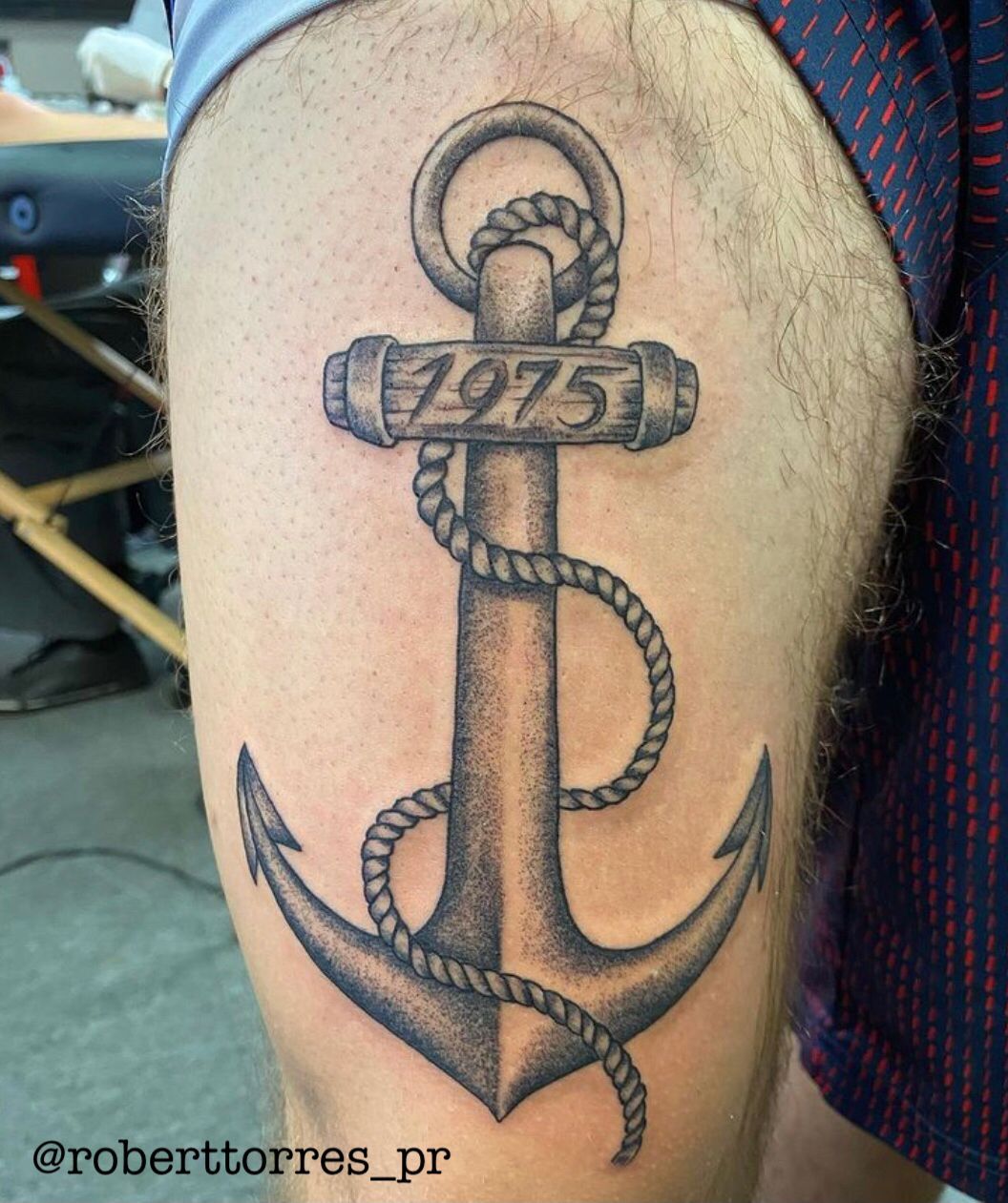 Tattoo of a large anchor with coiled rope and