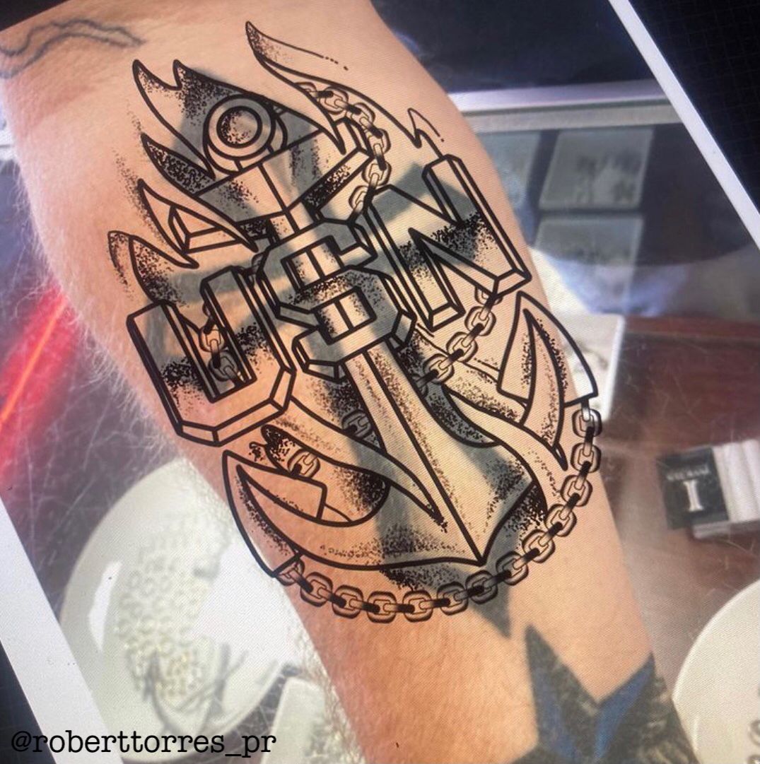 Tattoo on arm featuring an anchor, the letters
