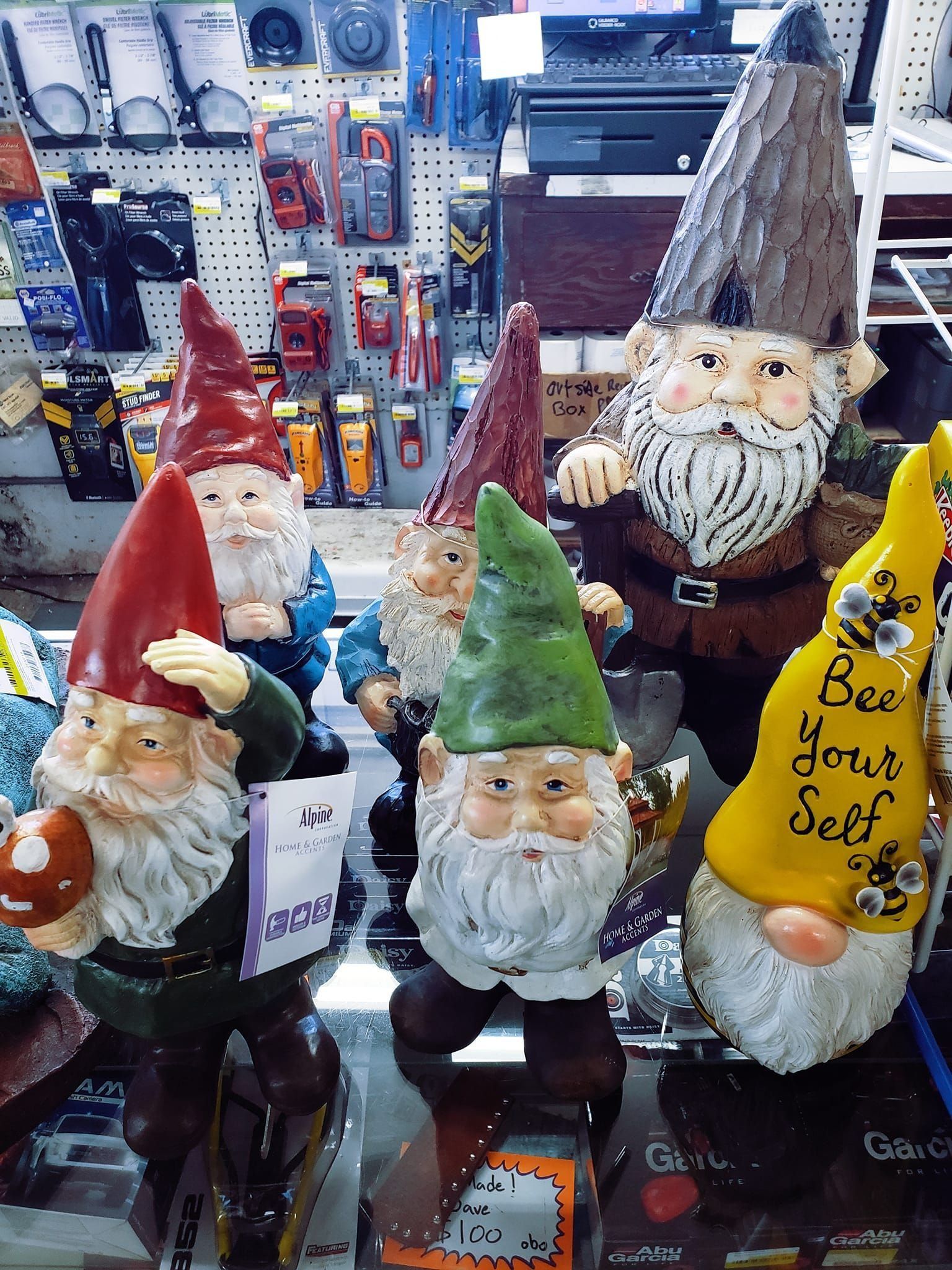 Gnome figurines with different colored hats and beards displayed in a shop.
