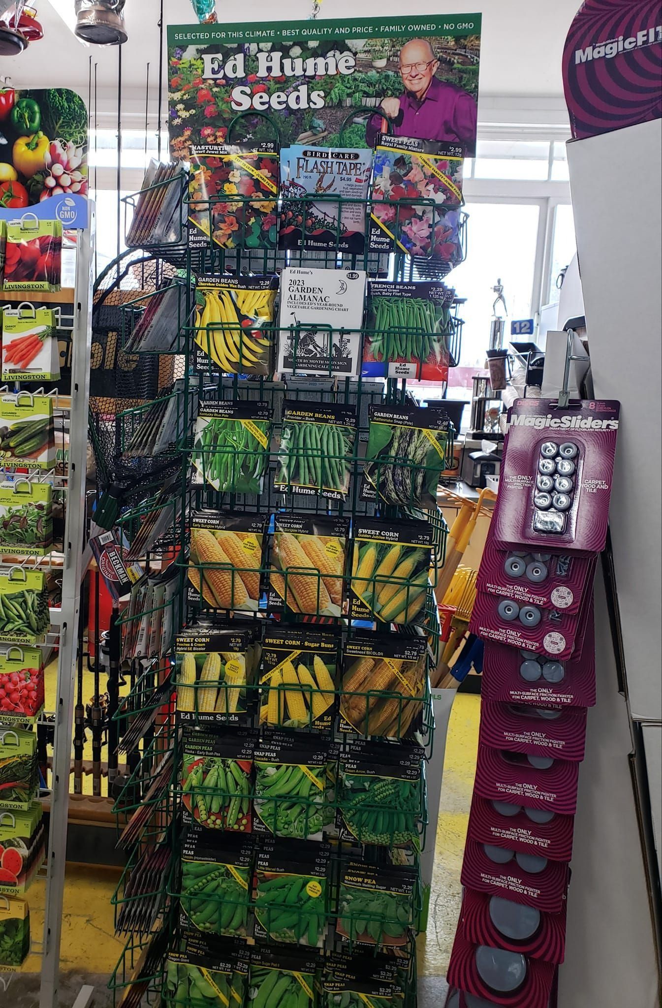 Seed packets on display in a store, including Ed Hume Seeds.
