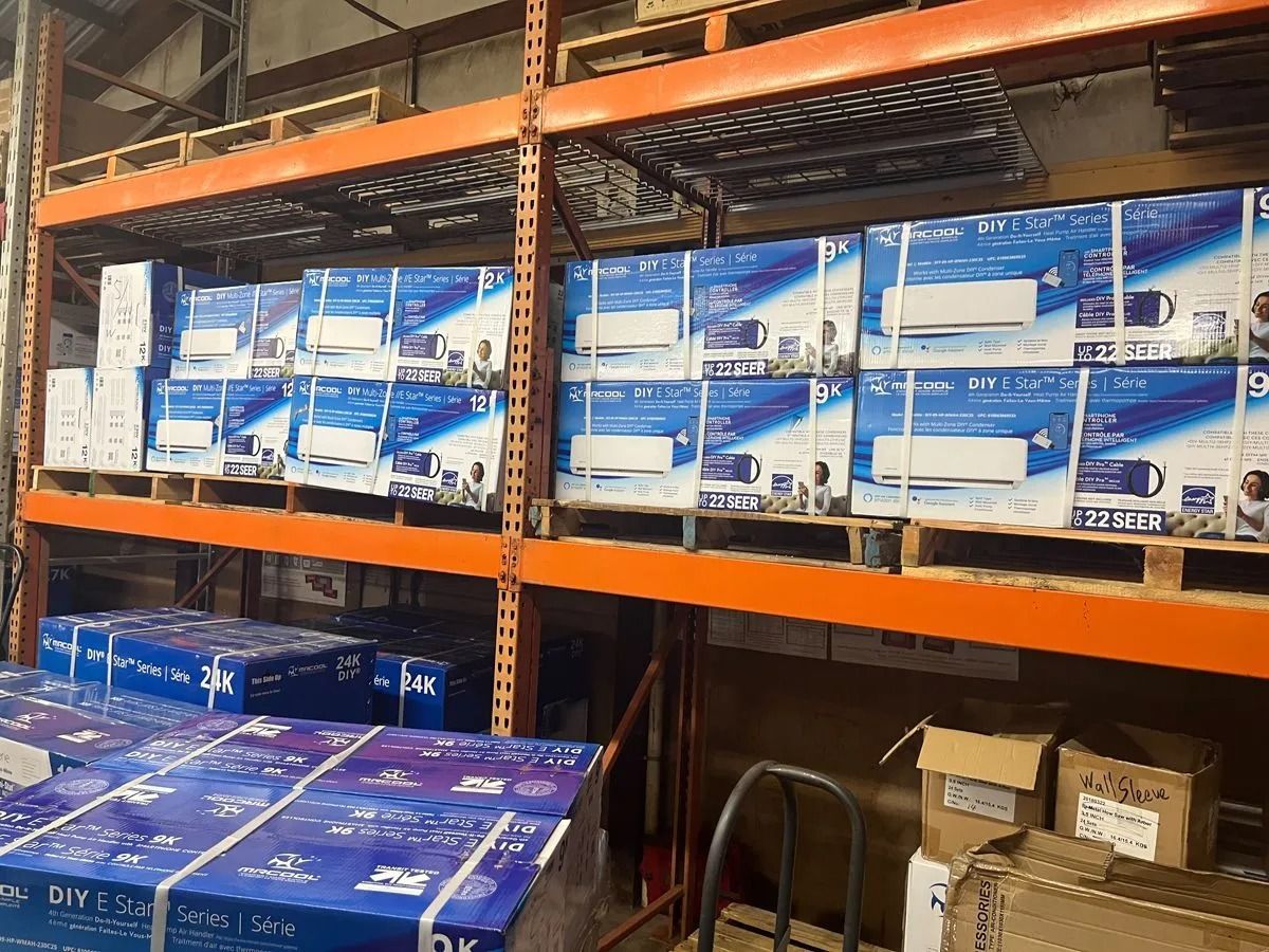Boxes of air conditioners stacked on warehouse shelves.
