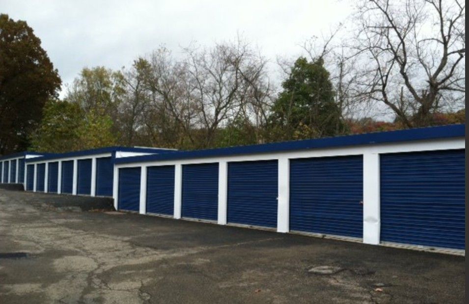 Exterior apartment garage painting project in Bondurant, Iowa by Harmony Painting.