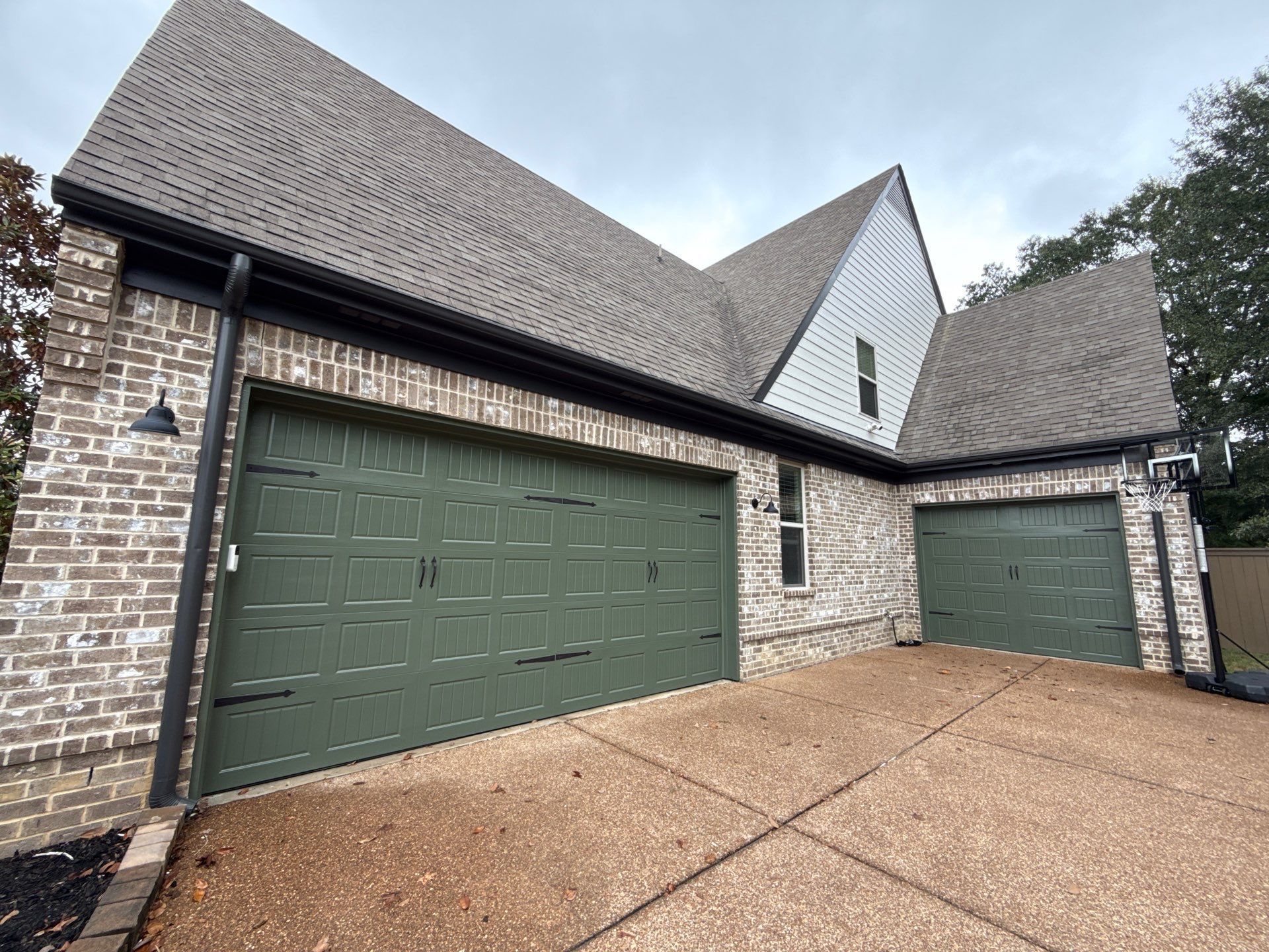 Exterior painted garage doors green in Urbandale, IA.